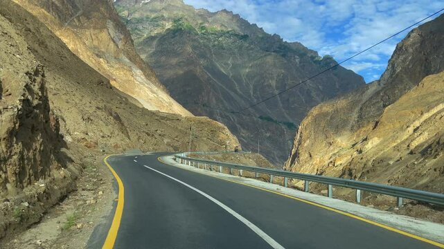 POV of the mountains while driving along the scenic JSR Road in Skardu Valley, Pakistan