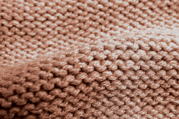 Knitted fabric in mocha mousse shade, closeup. Trendy color of 2025 year