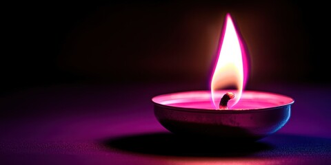 Candle is lit and has a pink flame