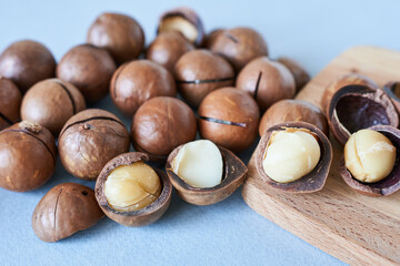 Macadamia nuts on a blue background. Macadamia nuts in close-up.