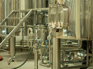 A small industry brewery's brewing tanks in a brewery that produces craft beer