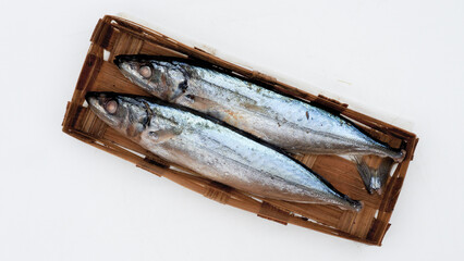 Pindang basket fish, Indonesian fish called ikan pindang or ikan keranjang in a bamboo basket isolated on white with copy space. Clipping path. Cooking content