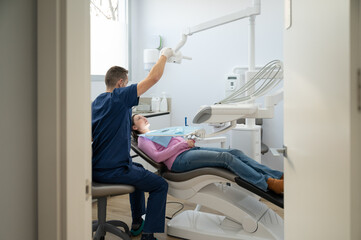 A dentist is working on a patient's teeth