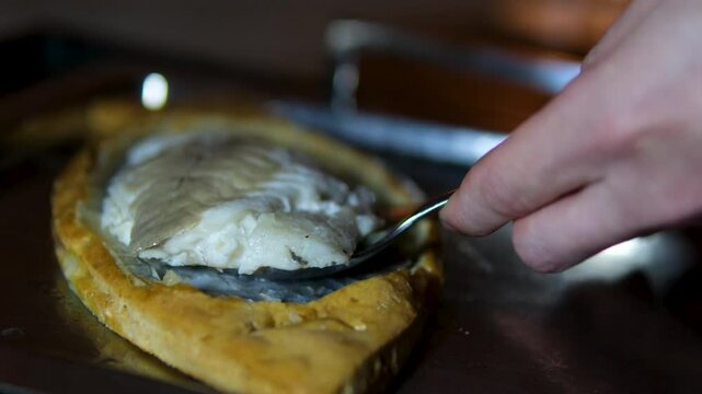 fish baked in dough, dorado Zander Fish Baked in Dough with Caviar and Cream Sauce. Restaurant food plate on white table. Delicious baked fish meal