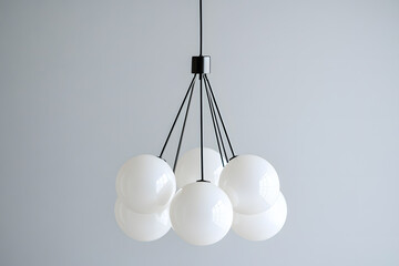 Modern chandelier with a cluster of hanging white glass orbs isolated on white background