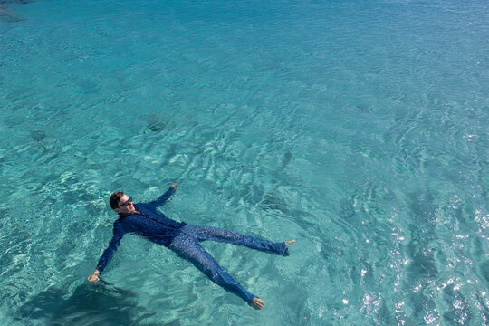Man swimming in water at ocean - Powered by Adobe