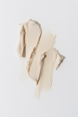 Closeup of beige hair styling wax or clay smear with a matte finish