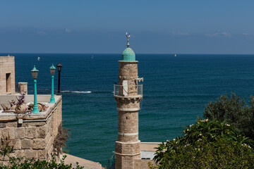  Sea and sky off the coast of Tel Aviv-Jaffa, Israel with a view of a turquoise mosque minaret and the blue Mediterranean sea.