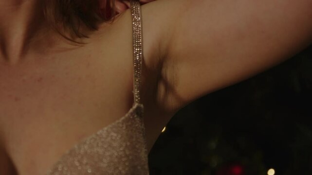 Close up of a beautiful woman putting on her bra in slow motion