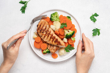 Grilled chicken breast and broccoli, cauliflower and carrots. Chicken meat with vegetables. Healthy food. White background top view