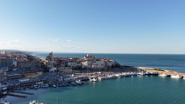 4k drone flight moving to the side footage (Ultra High Definition) of old town of Termoli, Italy. Spectacular Termoli port and picturesque Italian city on Adriatic sea.