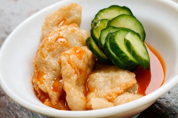 Fried dumplings with spicy sauce and cucumber.