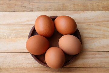 Fresh eggs on wood background