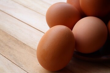 Fresh eggs on wood background