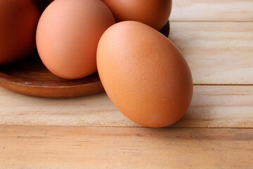 Fresh eggs on wood background