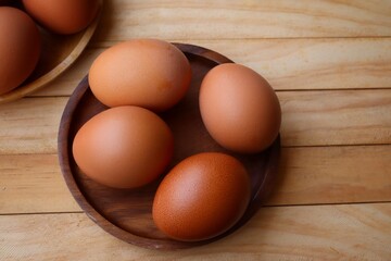 Fresh eggs on wood background