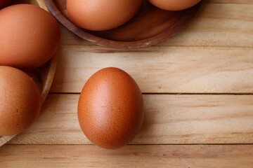 Fresh eggs on wood background