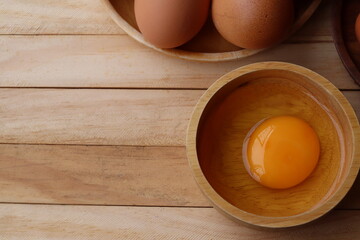 Fresh eggs on wood background