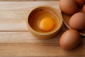 Fresh eggs on wood background