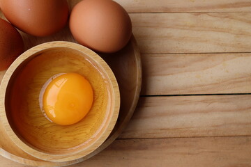 Fresh eggs on wood background