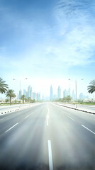 Empty highway leads to a modern cityscape with palm trees and bright blue sky overhead.