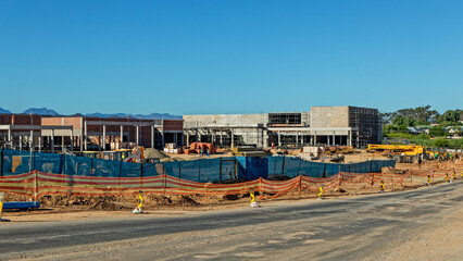 Obraz premium Large shopping center under construction with mountains in the background near Oudtshoorn in the Little Karoo, Western Cape, South Africa