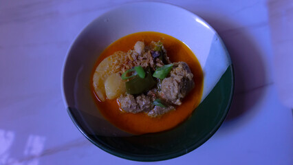Traditional Curry Dish with Meat and Vegetables served in a bowl. Usually eaten with bread or rice.