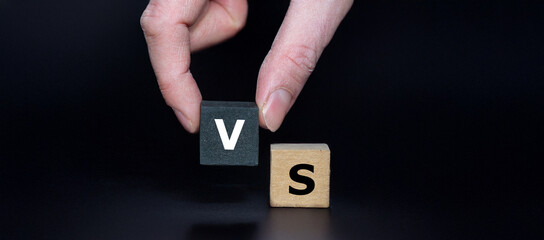 Cubes form the expression 'vs' (versus).