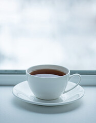 Cup with tea on the background of the winter landscape.