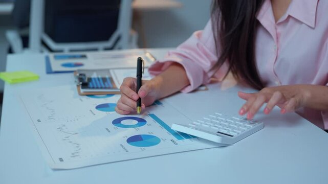 Skilled executive examining financial reports, interpreting market data, strategizing investment approach while working intently at modern corporate desk