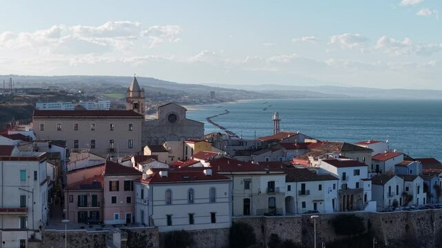 4k drone flight moving to the side footage (Ultra High Definition) of old town of Termoli, Italy. Spectacular Termoli beach and picturesque Italian city on Adriatic sea.