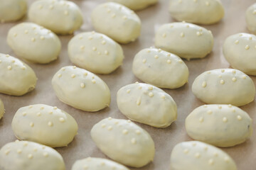 White chocolate potato dipped cookies on baking tray in bakery factory