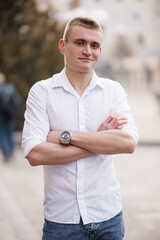 Confident Young Man in Casual Attire Posing Outdoors