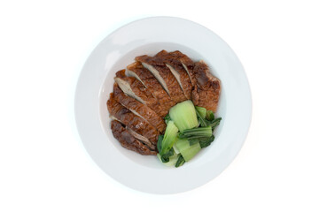Roast duck with kale, Bok Choy (Chinese mustard greens) in a white plate on a white table, top...