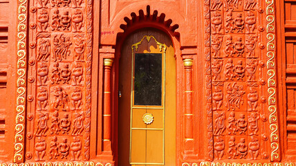 Terracotta carvings of Hindu deities, dancers, and musicians on the small shrine in front of...