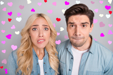 Portrait of attractive worried couple creating biting lips overthinking expect bad news isolated over gray pastel color background