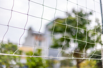 Close-up of sports netting with blurred outdoor background