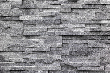 Gray stone wall with textured brick pattern