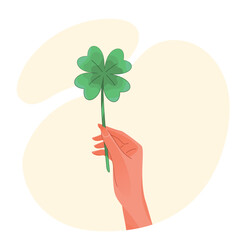 Hand holding a four-leaf clover for good luck concept