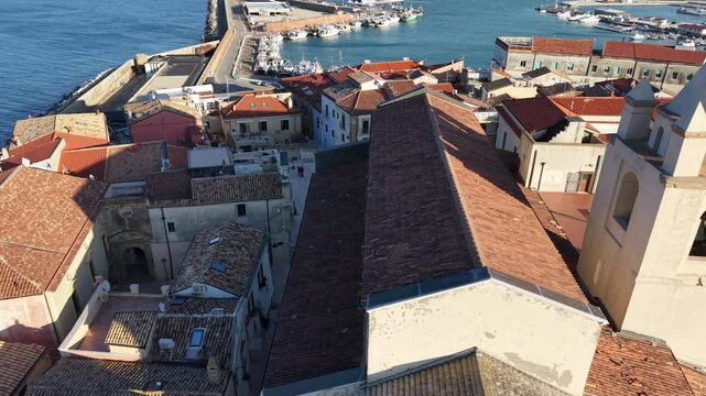 4k drone flight moving over the city footage (Ultra High Definition, 60fps) of old town of Termoli, Italy. Spectacular Termoli port and picturesque Italian city on Adriatic sea.