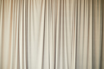 Obraz premium Beautiful curtain or curtain drapery. Natural soft light. Sandy, nude, cream color