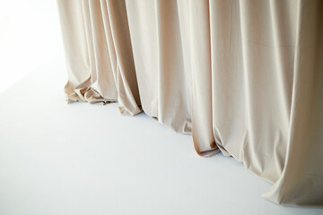 Beautiful curtain or curtain drapery. Natural soft light. Sandy, nude, cream color