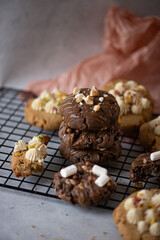 Stack of Chocolate and Decorated Cookies on a Cooling Rack