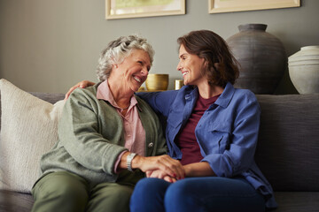 Senior mother having a nice conversation with adult daughter at home