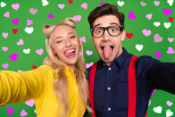 Photo of funny tricky young lady guy dressed pinup outfits tacking selfie showing tongues winking...