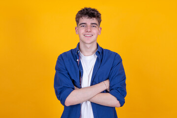portrait of young smiling teenager isolated on yellow background