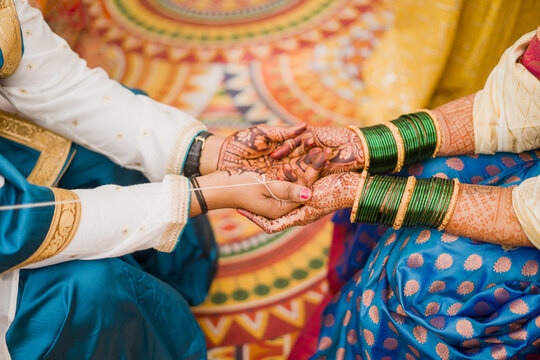 Man and woman holding hand for traditional hindu wedding rituals 