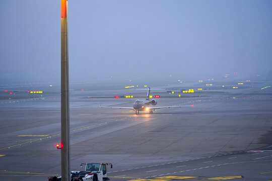 Black private jet Bombardier Global 5500 registration N5X taxiing at Swiss Airport Z&uuml;rich Kloten on a foggy winter day. Photo taken January 20th, 2025, Zurich Kloten, Switzerland.