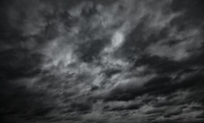 Obraz premium dark dramatic sky with black stormy clouds before rain as abstract background, extreme weather