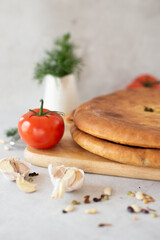 Traditional Bread with Tomato, Garlic, and Herbs on a Wooden Board